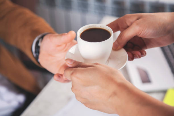 istock woman and boss hand coffee 1173634778