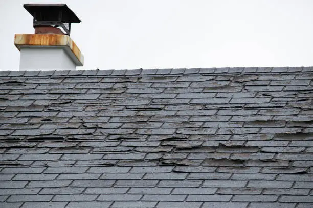 Damage to asphalt and asbestos shingles, gutter systems, chimney and roof flashing on residential home