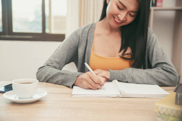 istock Female hand planner or organizer writing daily appointment 1173637521