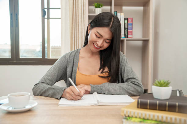 istock Female hand planner or organizer writing daily appointment 1173637526
