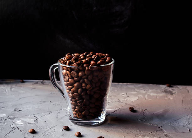 istock Coffee beans in a glass cup on a grey grunge background 1173637821
