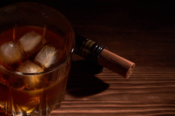 istock glass of whiskey with cigar 1173639040