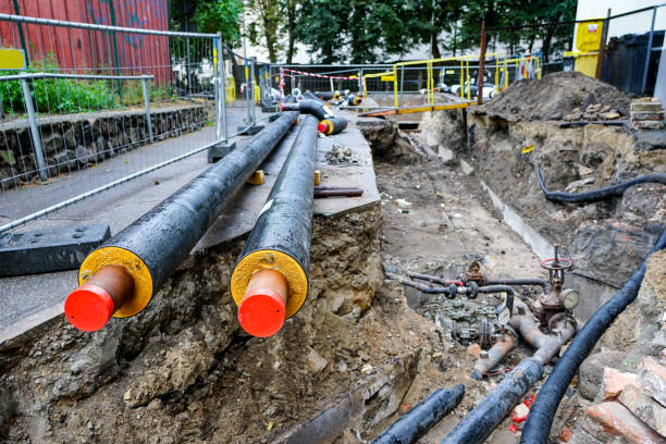 istock underground heating system pipes replacement on the city street 1173641559
