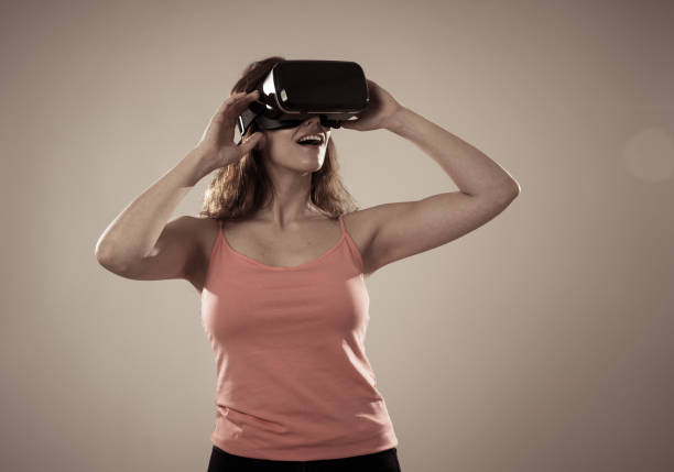 istock Innovations and new technology concept. Amazed woman getting experience using VR headset glasses, feeling excited about simulation, exploring virtual reality making gestures interacting with new virtual world. 1173644888