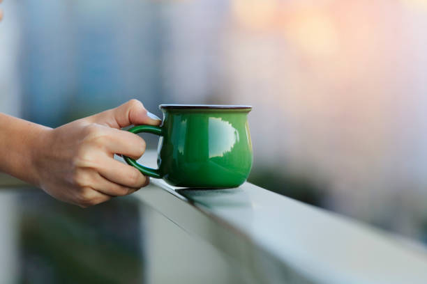 Female hand holds a cup of coffee