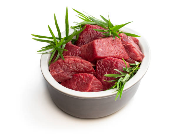istock Sliced raw beef with tarragon herb isolated on white 1173647338