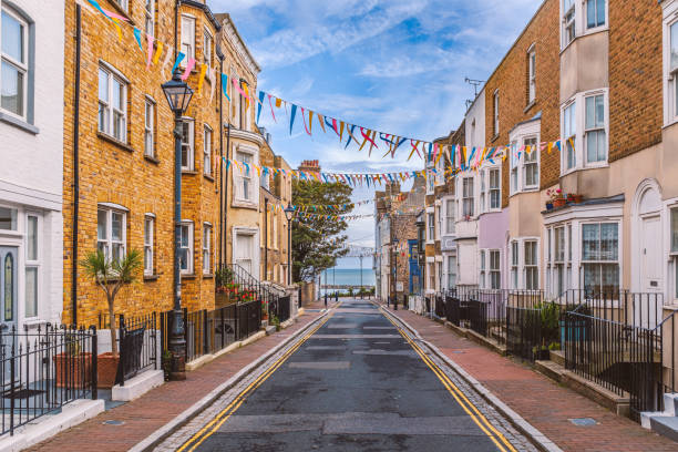 A view along Addington Street, Ramsgate toward the sea. Bunting is flying in preparation for the annual street fair. The street is part of Ramsgate's burgeoning music and art scene. A view along Addington Street, Ramsgate toward the sea. Bunting is flying in preparation for the annual street fair. The street is part of Ramsgate's burgeoning music and art scene. ramsgate stock pictures, royalty-free photos & images