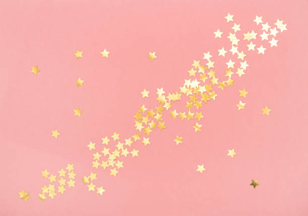 istock Golden confetti pink color background Holidays flat lay 1173648830