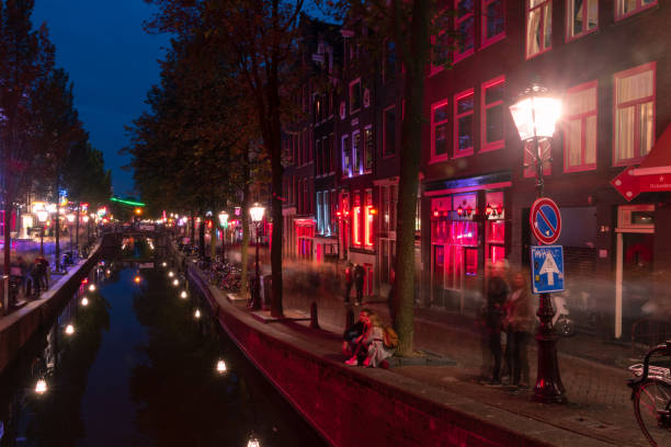 night wiev of red light district with sex workers waiting for their next customer. - sex district imagens e fotografias de stock