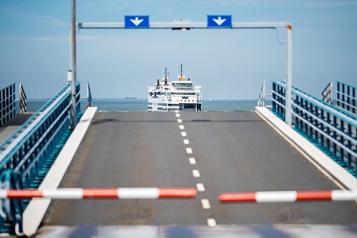 Texel, Netherlands, July 22, 2019: Teso Ferry to Texel arrival at Den Helder, netherlands. Barrier in front of ramp to car ferry