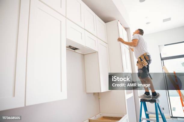 Fitting A Kitchen Stock Photo - Download Image Now - Cabinet, New, Construction Industry