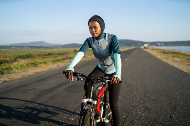 istock Female biker on road 1173659289