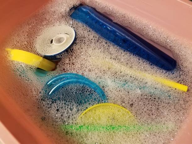 istock plastic lids and bottles in soapy water being cleaned 1173661039