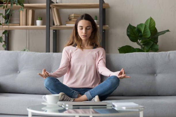 istock Calm woman relax on couch meditating practicing yoga 1173666052