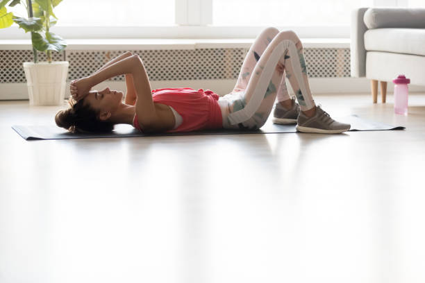 istock Exhausted young woman relax after workout at home 1173666154