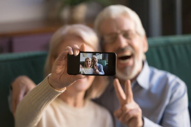istock Happy old couple taking selfie on cellphone, focus on display 1173667023