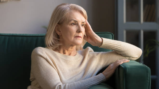 Pensive middle aged lady looking away sit alone at home Pensive thoughtful middle aged lady looking away sit alone at home feel anxious lonely, sad depressed melancholic old mature woman suffer from sorrow grief thinking of problem suffer from solitude widow stock pictures, royalty-free photos & images