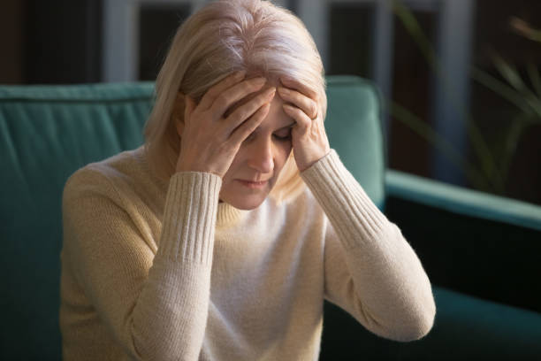 istock Upset stressed tired old mature woman coping with headache concept 1173667073