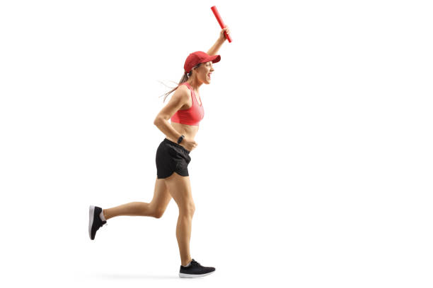 istock Young female runner on a relay race carrying a baton 1173668238