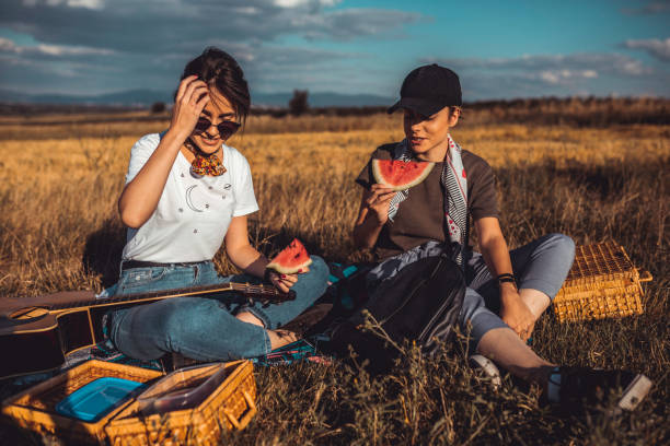 istock Sisters eating watermelon during a picnic on a sunny day 1173669921