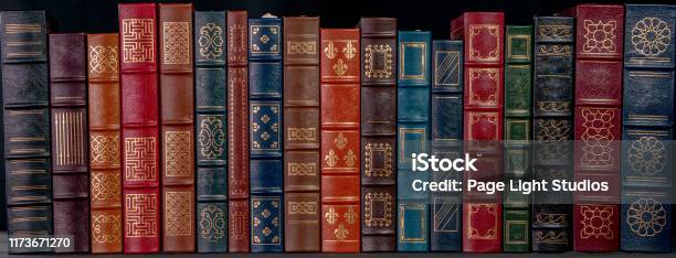 A Stack Of Leather Bound Books With Gold Decoration Stock Photo - Download Image Now