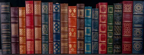 Photo of A stack of leather bound books with gold decoration