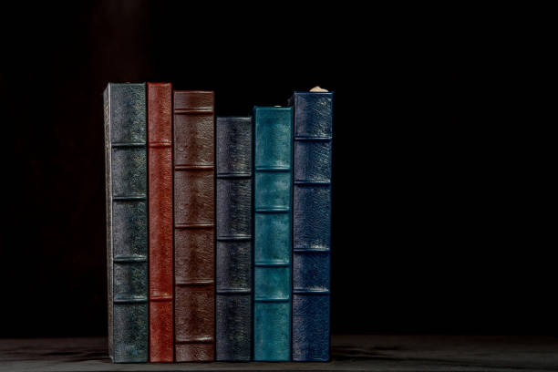 a stack of leather bound books - book book spine in a row library imagens e fotografias de stock