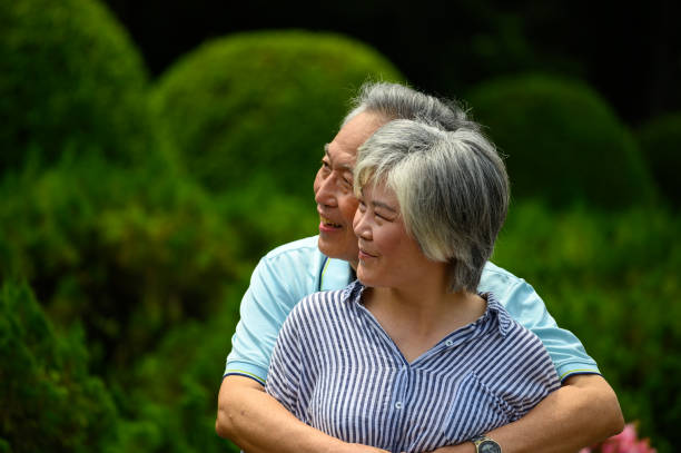 istock Elderly couple embracing at park 1173671490