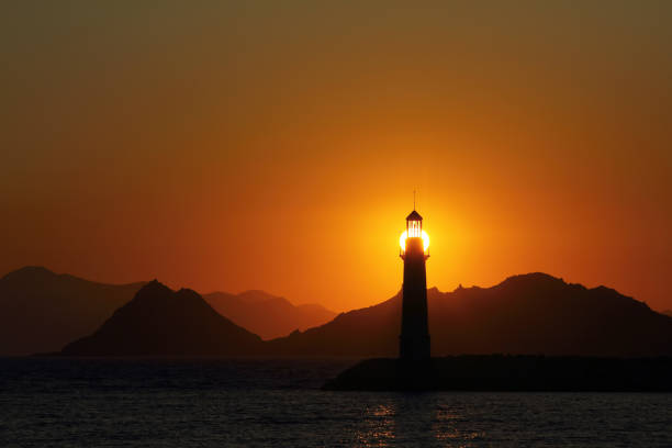 istock Seascape at sunset. Lighthouse on the coast 1173671703