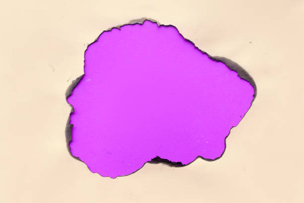 istock Vibrant color paper background with burnt hole in the middle 1173672348