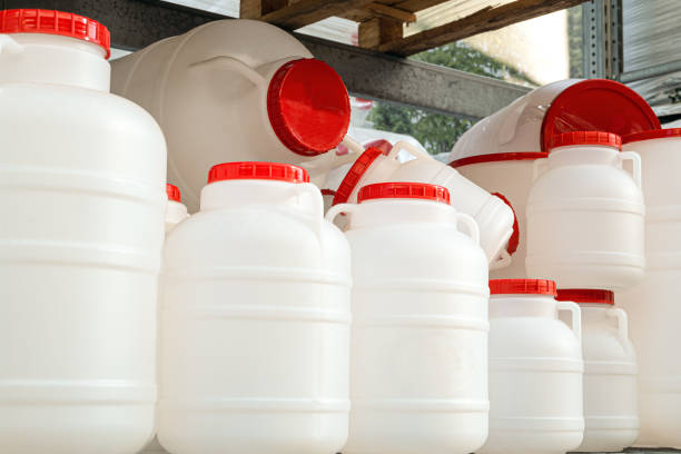 istock Empty white plastic water-cans with red lids on a rack. Domestic drinking water tanks. 1173672651