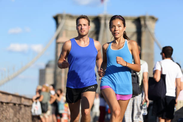 istock City running couple on Brooklyn bridge 1173672795