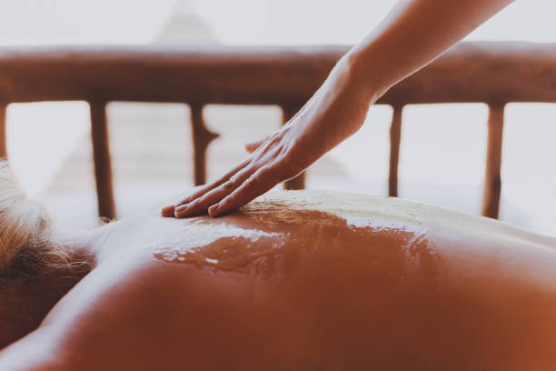 Woman receiving a back massage in a spa center.