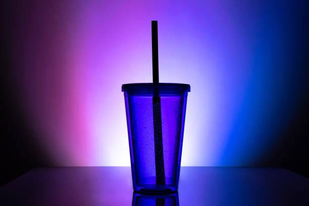 istock Drink cup. Black plastic straw in cocktail bottle. 1173675486
