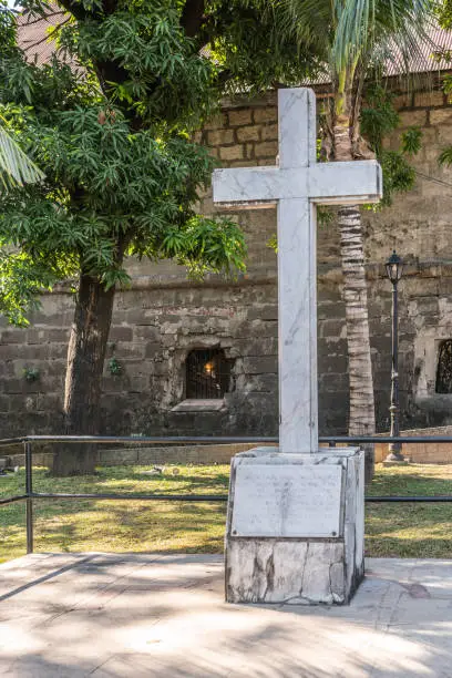 Manila, Philippines - March 5, 2019: Fort Santiago. White marble cross as memorial for execution by Japan of over 600 Filipino and American prisoners at the fortress at end of February 1945.