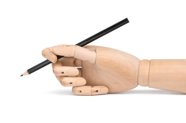 istock Black pencil in wooden hand 1173679457