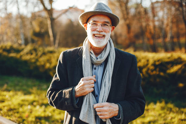 istock Elegant old man in a sunny autumn park 1173698103