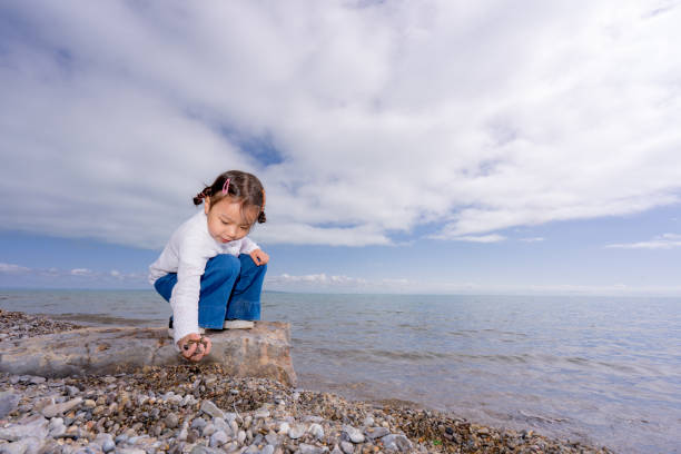 istock a young girl playing by the lake side 1173712833
