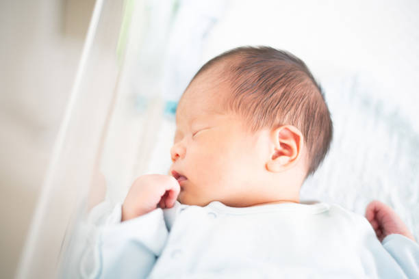 istock Newborn baby on crib 1173712888