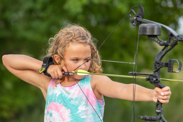 istock Young Girl Practicing Archery at Outdoor Shooting Range 1173713783