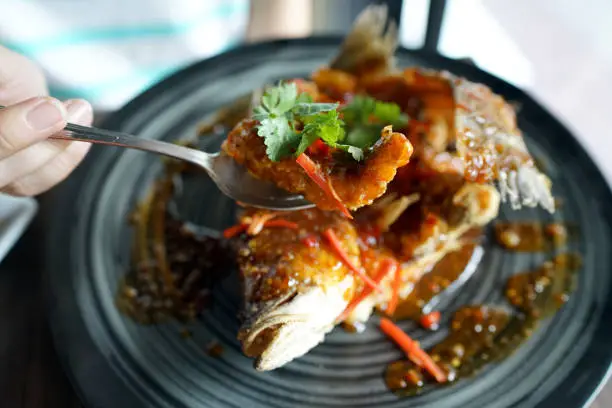 Photo of Deep fried Sea bass with sweet and sour sauce, Traditional Thai food recipe.