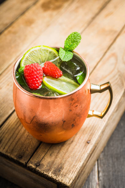 istock Raspberry and lime cocktail in copper mug (variation of Moscow mule) on the rustic background 1173717991