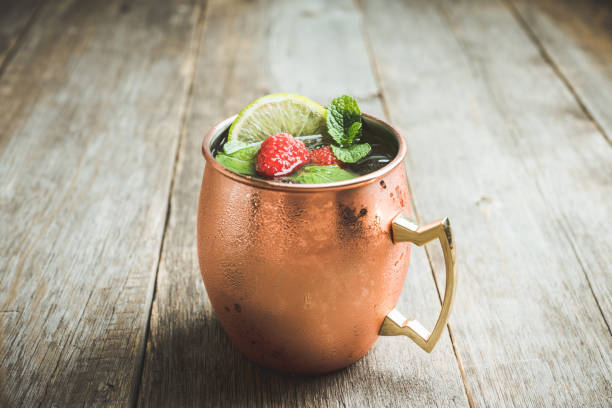 istock Raspberry and lime cocktail in copper mug (variation of Moscow mule) on the rustic background 1173718034