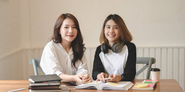 istock Two adorable young freelancer smiling to the camera while working on their project 1173720987