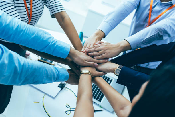 Business people showing unity and collaboration gesture
