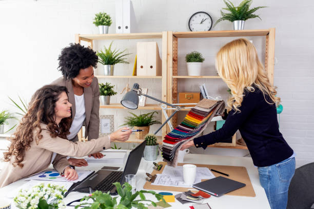 istock Three business woman at the office choosing material from samples 1173727571