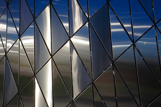 Abstract background of polished metal panels of a triangular shape.