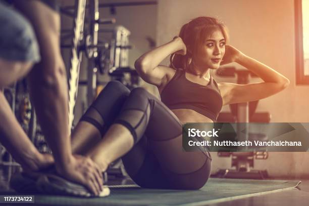 Fitness Woman Doing Situps Exercisesfemale Doing Abs Workout With Personal Trainer Stock Photo - Download Image Now
