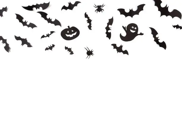 Photo of Halloween paper decorations on white  background. Halloween concept. Flat lay, top view, copy space