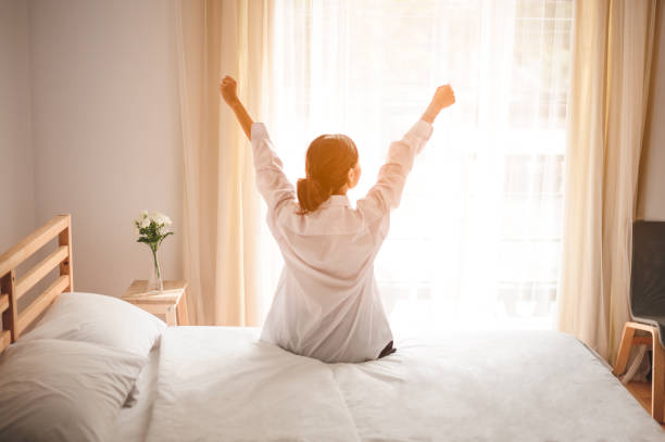 istock Woman stretching in bed after waking up 1173735404